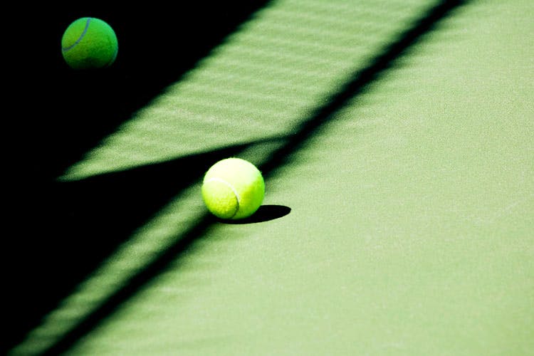 Green,Ball,Sports equipment,Sport venue,Tennis court,Tennis ball,Line,Table,Tennis Equipment,Real tennis